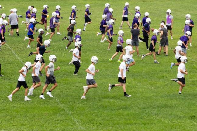 Players run through drills on the first day of football practice on Aug. 19, 2024.