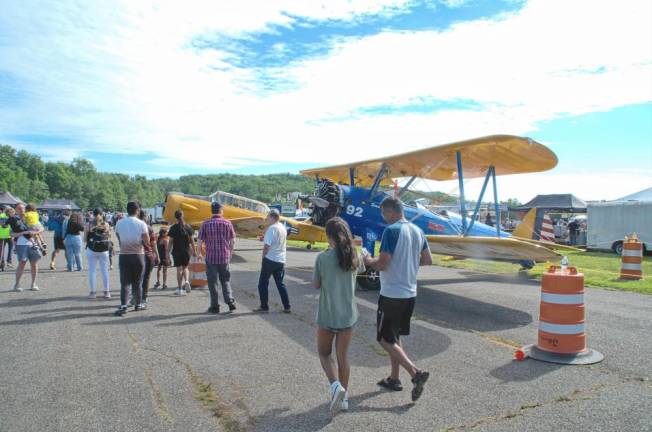 People strolled and enjoyed looking at the vintage planes on display.