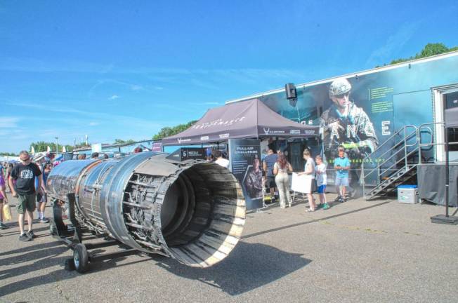 On display was an F100 jet engine that powers up the F-15 and F-16 fighter jets used by the U.S. Air Force. To the right, people were lined up to go into an F-5 jet simulator.