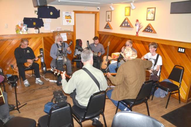 Don “Banjo” Smith, second from left, sang and played his banjo with other musicians.