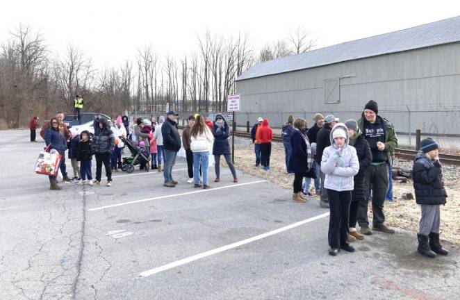 Residents gather to see the train come and whisk the toys away over the weekend in Warwick.