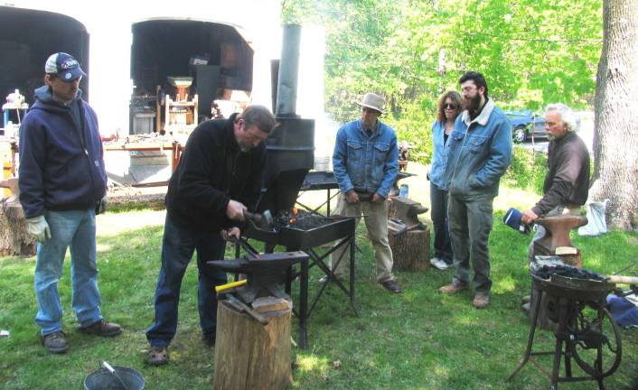 On Saturday and Sunday, April 28-29, the charcoal fires were red hot as a group of students and their instructor hammered out useful metal objects on anvils behind the historic Baird&iacute;s Tavern at 105 Main St. From left, Joe Hearon, professional blacksmith Adriaan Gerber, Robert Schmick, director of the Historical Society of the Town of Warwick, Cathy Erlean-Goddard, Orion Blake and Vic Stockman.