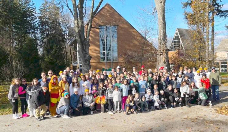 The volunteers and runners gather in front of St. Stephen’s Church.