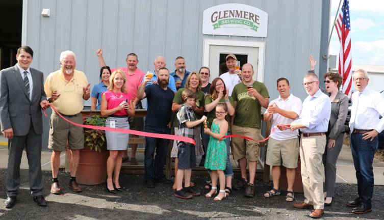 Photo by Roger Gavan On Thursday, June 28, Town of Warwick Supervisor Michael Sweeton (far right), Florida Mayor Daniel Harter Jr. (far left) and members of the Warwick and Florida Chambers of Commerce joined the Sandor family owners (center), their relatives, friends and associates for a ribbon cutting ceremony to celebrate the Glenmere Brewing Company's second anniversary.