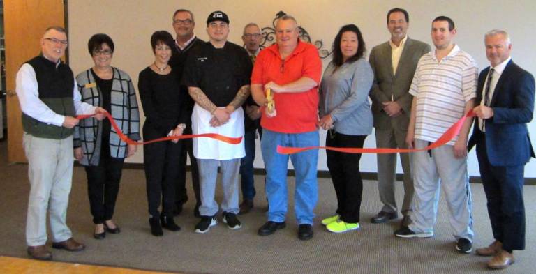 Photo by Bea Arner On Wednesday, Nov. 1, Hickory Hill Catering Food and Beverage Director Robert Freeman and Executive Chef Phillip Dunn (center) were on hand to cut the ribbon and greet notable friends, family, employees and members of the community at Hickory Hill Golf Course.