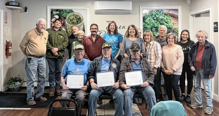 James Sosler, Thomas Fuller Sr., and Robert Scott III (front) hold the certificates given to each of them by the Florida Chamber of Commerce.