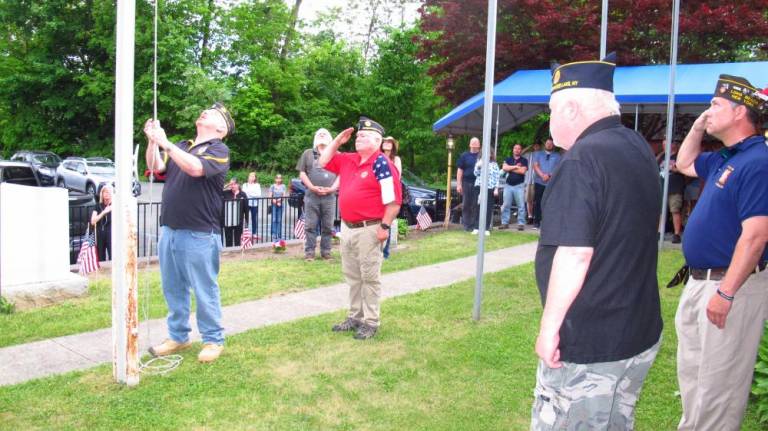 All veterans salute as GWL American Legion CDR Walter Kittle attaches the SAR flag to the flagpole and hoists it up.