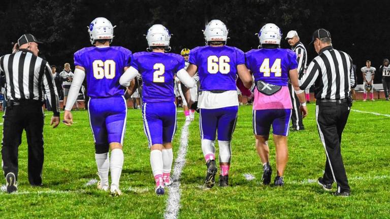 Warwick football captains Michael Miller (#60), Brody Frederick (#2), Michael Hennessy (#66), and Grant Havell (#44) approach for the coin toss ahead of their 34-15 win over the Panthers. Not pictured: captain Wyatt Vreeland (#41). Senior leadership has been the key to Warwick’s 7-0 start.