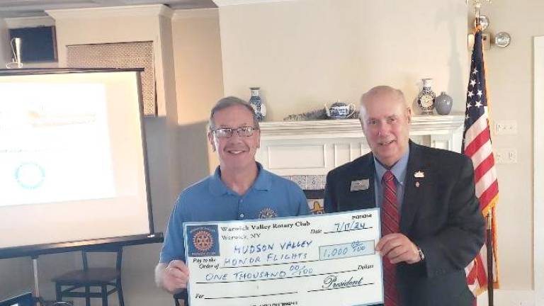 <b>Neil Sinclair, left, who completed his fourth term as Warwick Valley Rotary Club president on June 30, presents a $1,000 donation check to Bill Sestrom, a former Newburgh Rotary Club president and charter board member of the Hudson Valley Honor Flight. </b>